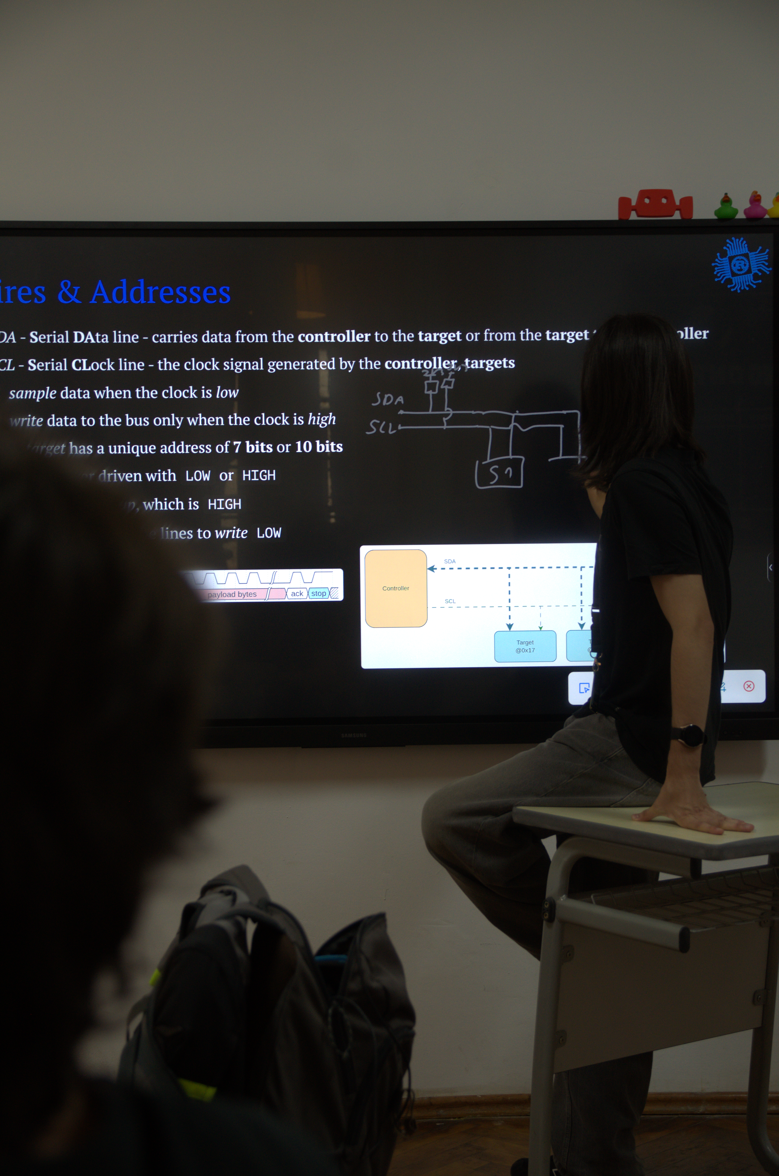 instructor pointing at i2c bus diagram on screen
