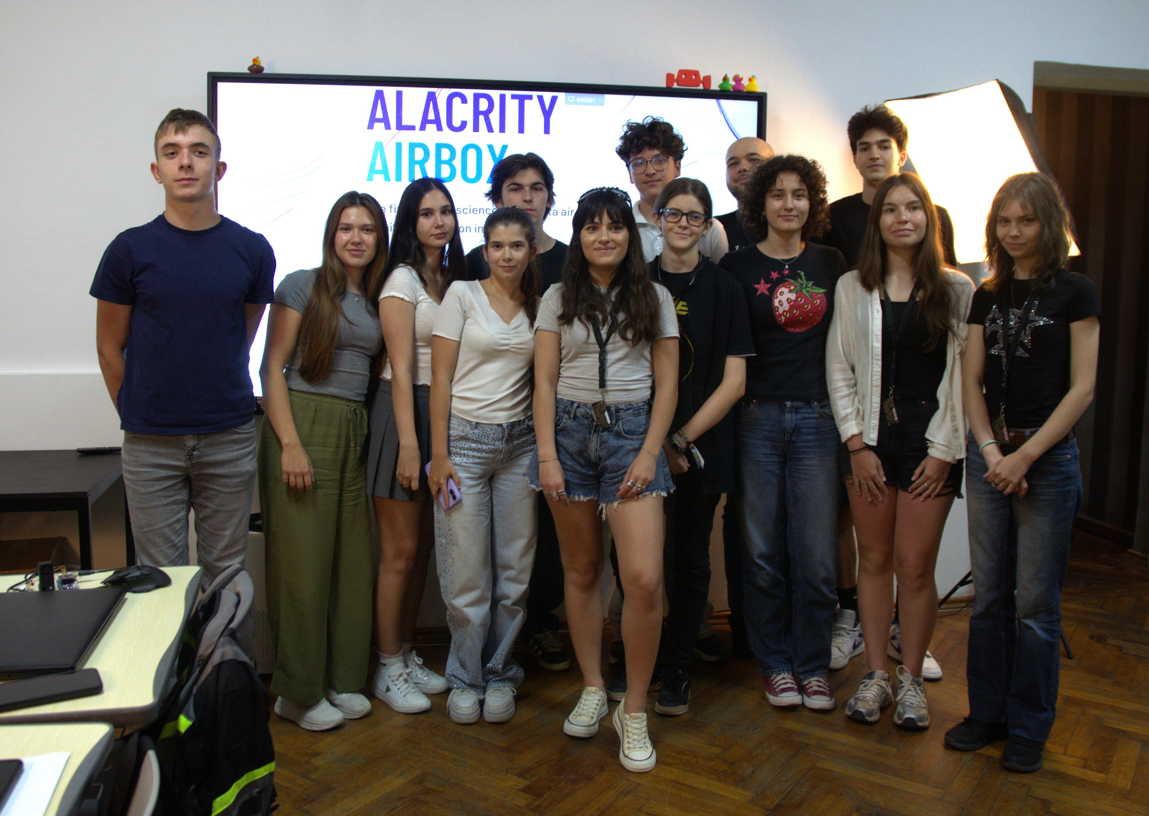 Group photo of AirBox Bootcamp students in front of a screen reading Alacrity AirBox
