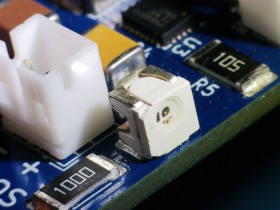 Side view close-up of surface-mount components on a blue AirBox PCB